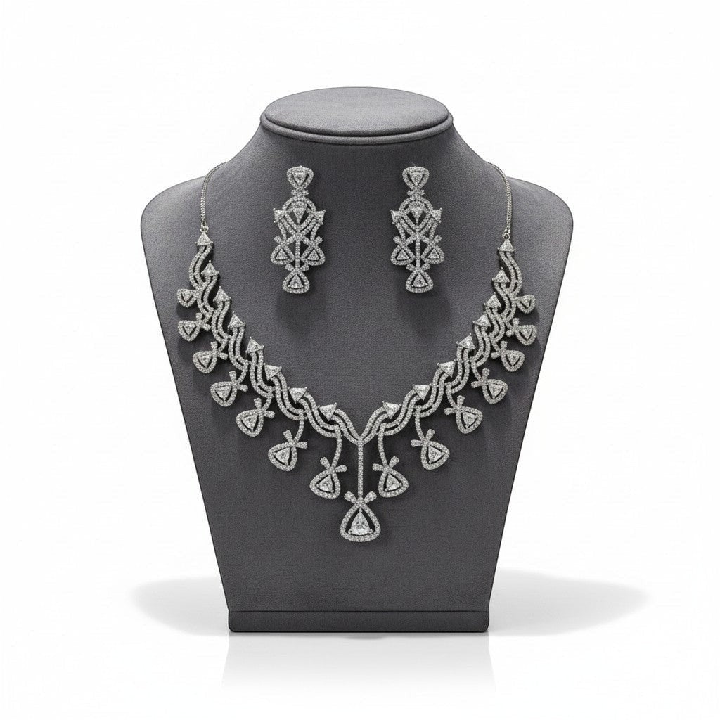 AVIRI diamond necklace and earring set with geometric pattern and sparkling stones. Lustrous metal finish.