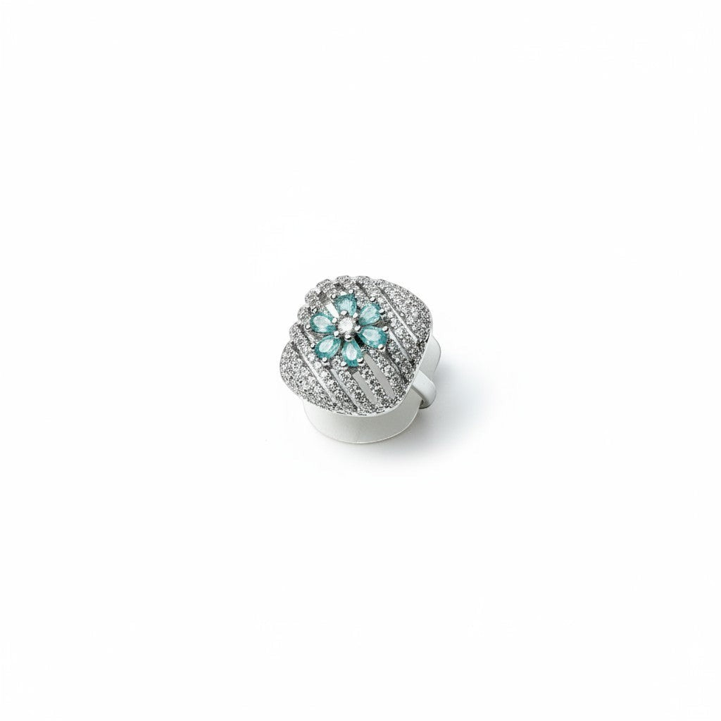 AVIRI sterling silver ring with blue sapphire and diamond flower design. Intricate detailing and polished finish.