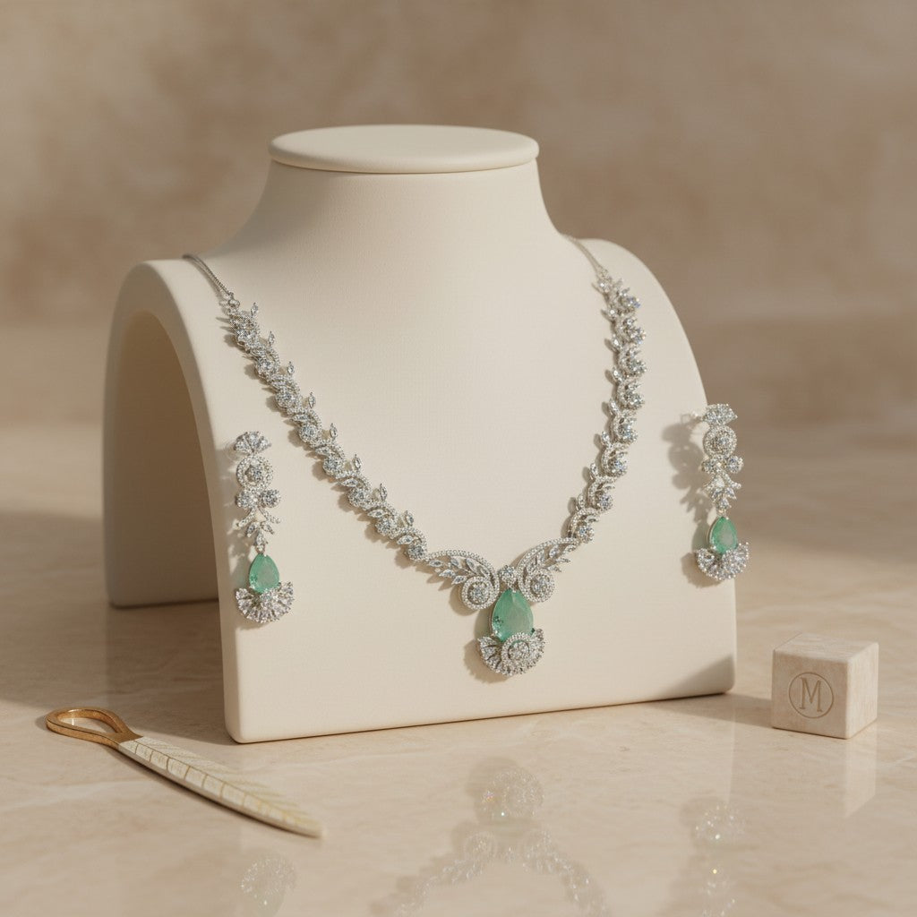 AVIRI rhodium-plated sterling silver necklace and earring set with cubic zirconia and emerald-green pear-shaped gemstones.