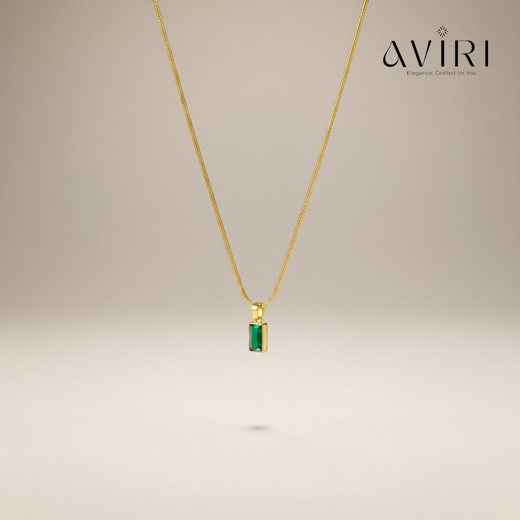 AVIRI gold plated necklace with a rectangular emerald green pendant on a delicate chain. Anti-tarnish finish.