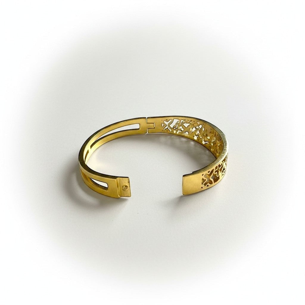 AVIRI gold-tone metal cuff bracelet with ornate filigree openwork design and polished finish.