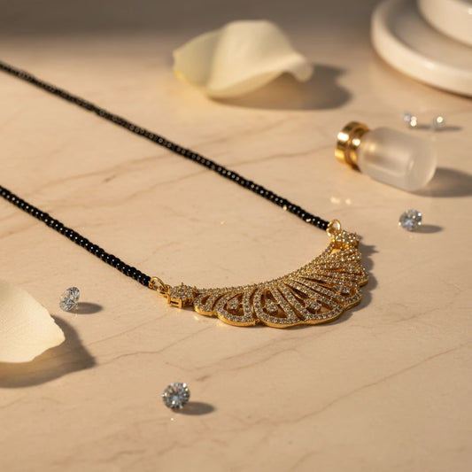 AVIRI gold plated necklace and earring set with black beads and cubic zirconia stones in a peacock feather design.