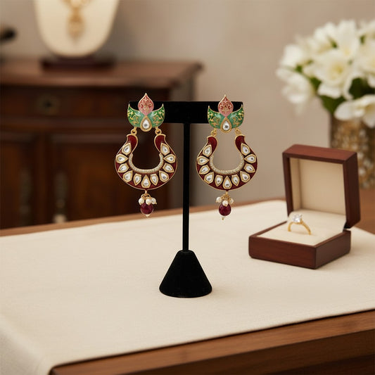 AVIRI red enamel Kundan Chandbali earrings with floral detailing, white stones, pearl and ruby drops.