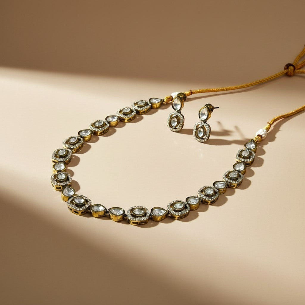 AVIRI American Diamond Necklace and Earring Set with clear stones and gold-tone chain. Features round and oval settings.