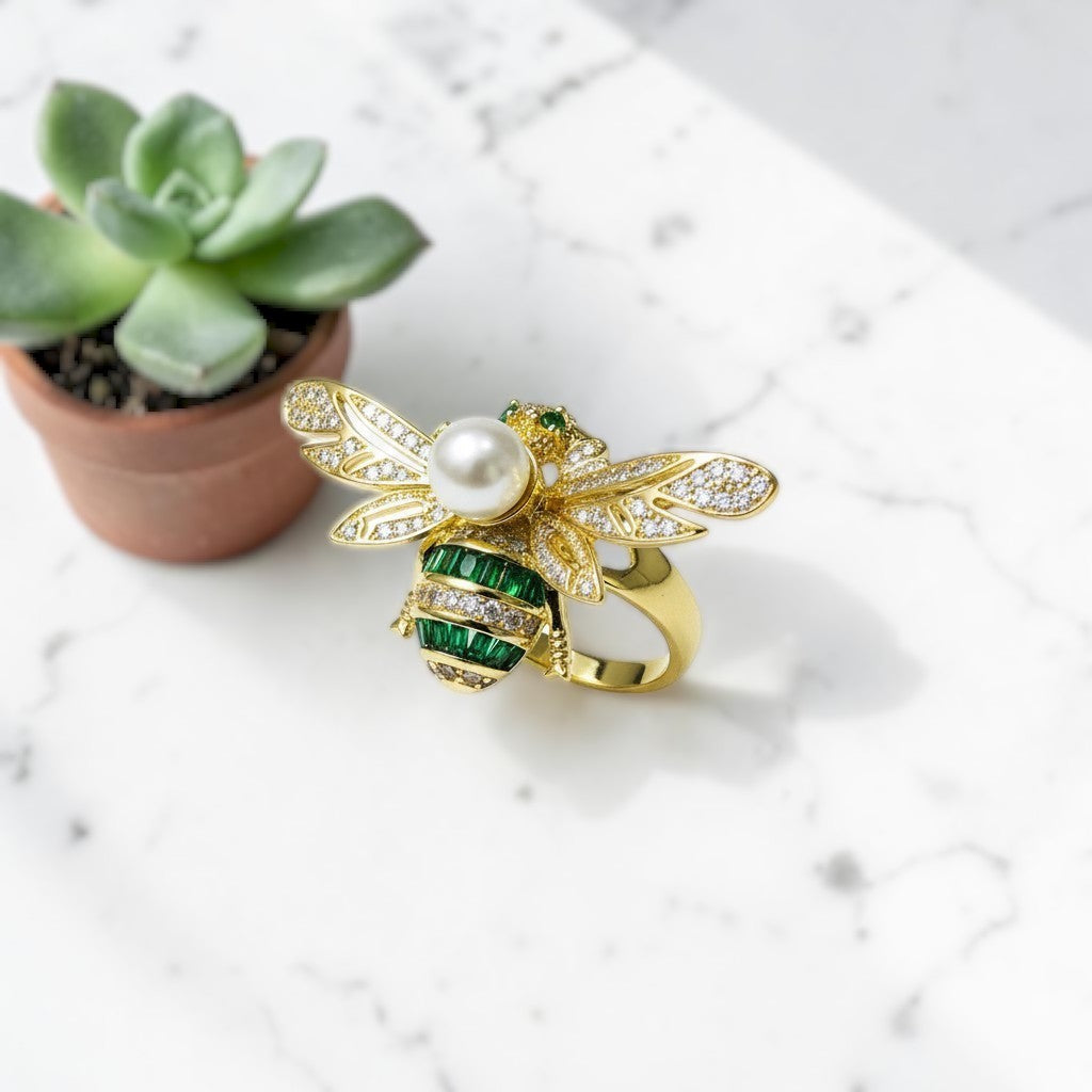 AVIRI gold-tone bee ring with pearl body, emerald accents, and cubic zirconia wings.