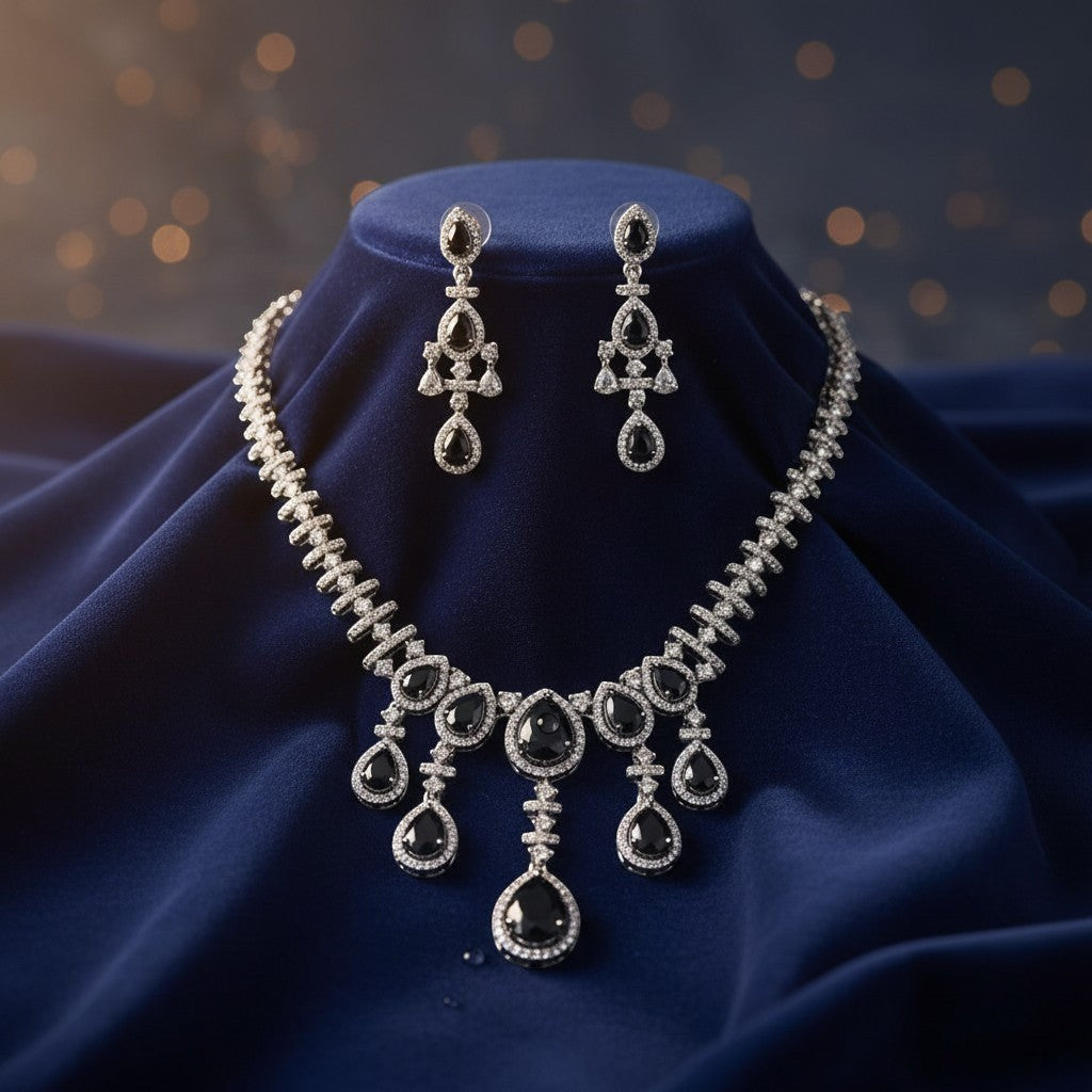 AVIRI black gemstone and silver necklace and earring set with sparkling accents. Elegant cascade design.