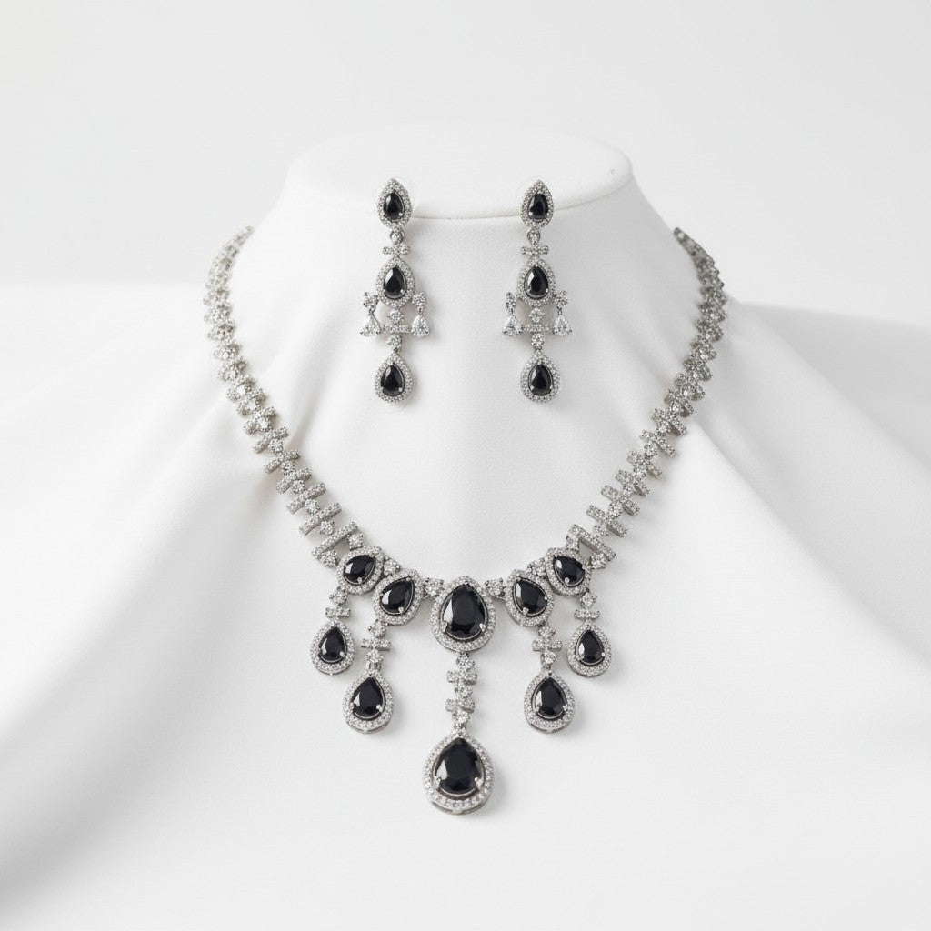 AVIRI black gemstone and silver necklace and earring set with sparkling accents. Elegant cascade design.