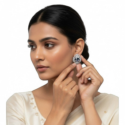 AVIRI luxury blue AD stud earrings with silver polish finish and halo of small stones. Elegant artificial jewelry.