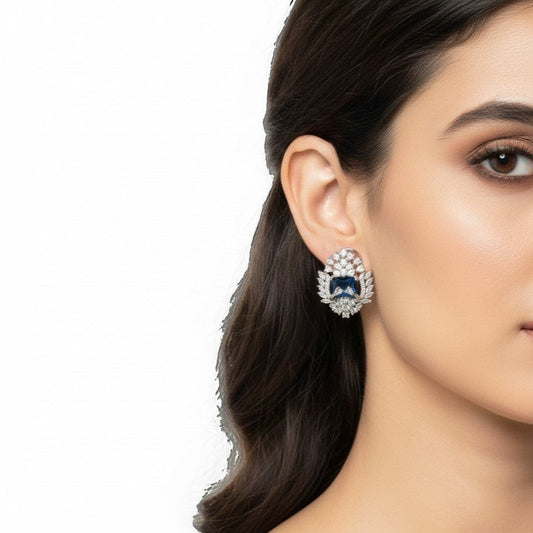 AVIRI luxury blue AD stud earrings with silver polish finish and halo of small stones.