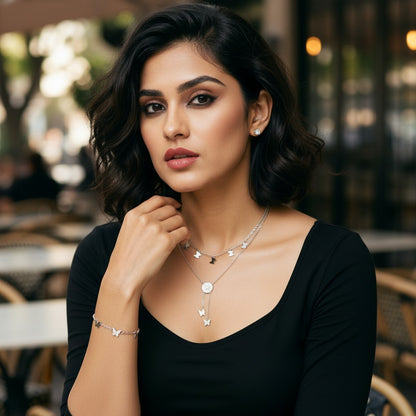 AVIRI silver plated double layered necklace with butterfly charms and a central circular pendant. Hypoallergenic and anti-tarnish.