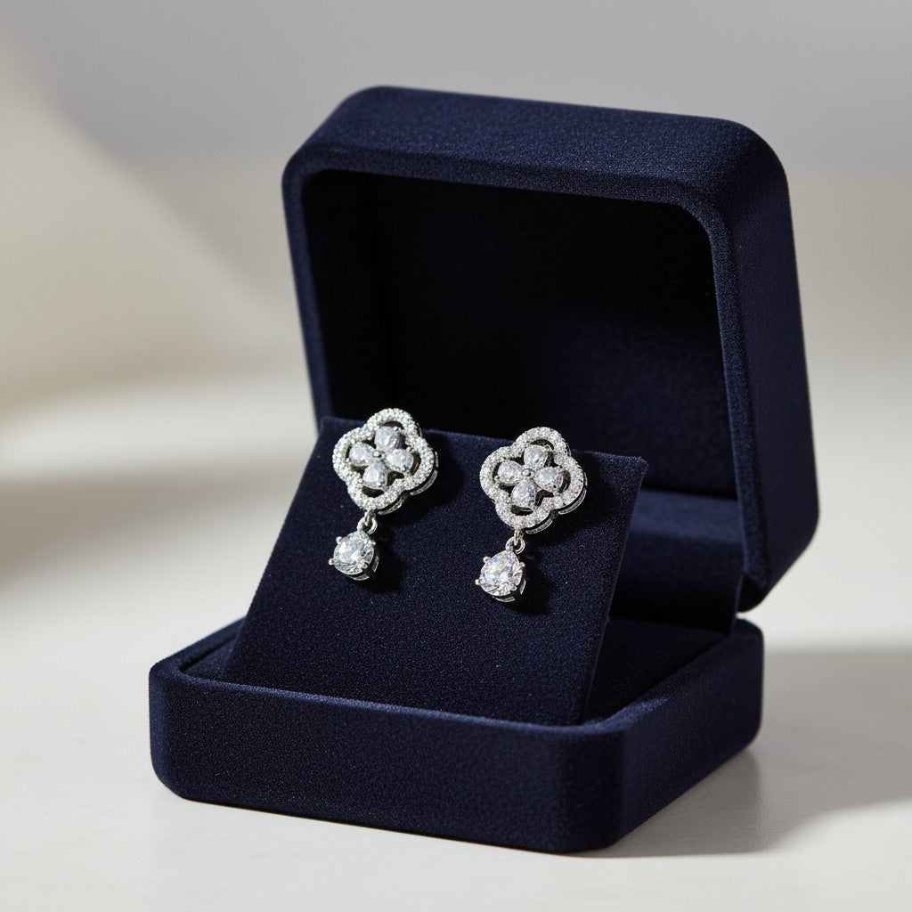 AVIRI silver-tone drop earrings with clover design and cubic zirconia stones. Elegant and sparkling.