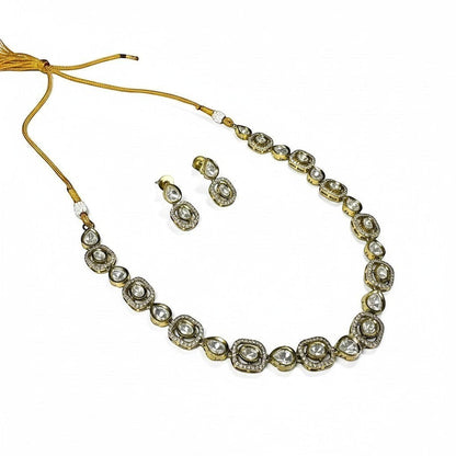 AVIRI gold-tone necklace and earring set with clear stones in round and oval settings. Intricate detailing.