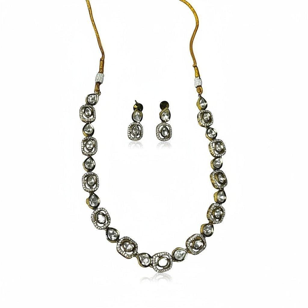 AVIRI gold-tone necklace and earring set with clear stones in round and oval settings.