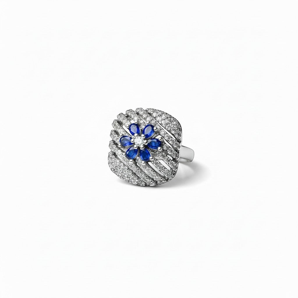 AVIRI sterling silver ring with blue sapphire and diamond flower design. Intricate detailing.