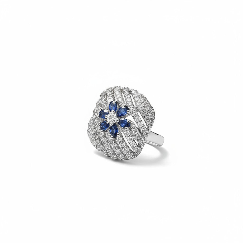 AVIRI sterling silver ring with blue sapphires and diamonds in a floral design. Features intricate detailing and a polished finish.