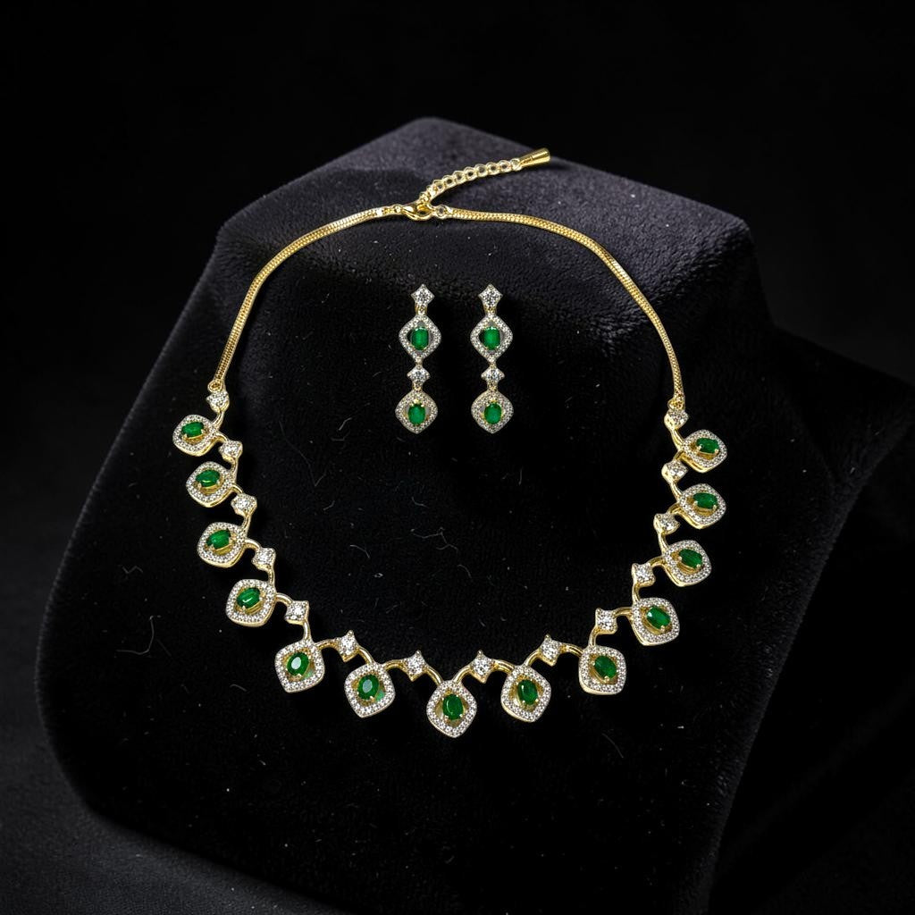 AVIRI gold-tone necklace and drop earrings set with emerald-cut green stones and clear crystals.