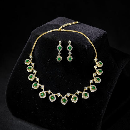 AVIRI gold-tone necklace and drop earrings set with emerald-cut green stones and clear crystals.