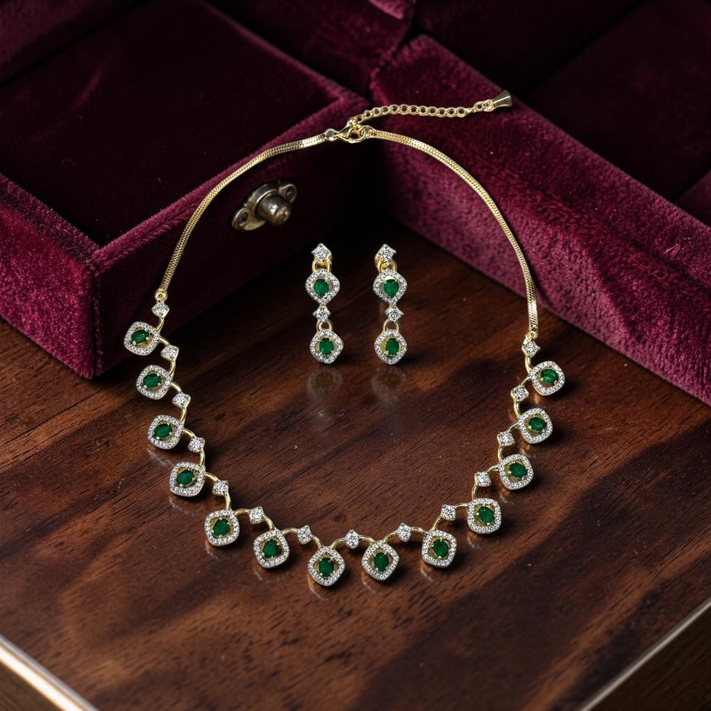 AVIRI gold-tone necklace and drop earrings set with emerald-cut green stones and clear crystals.