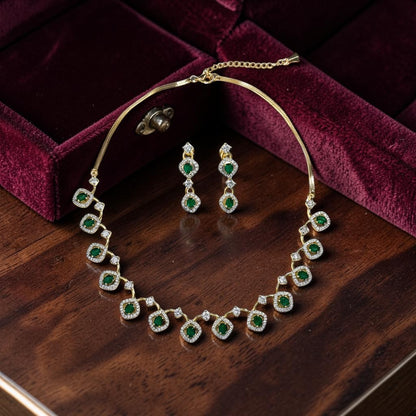 AVIRI gold-tone necklace and drop earrings set with emerald-cut green stones and clear crystals.