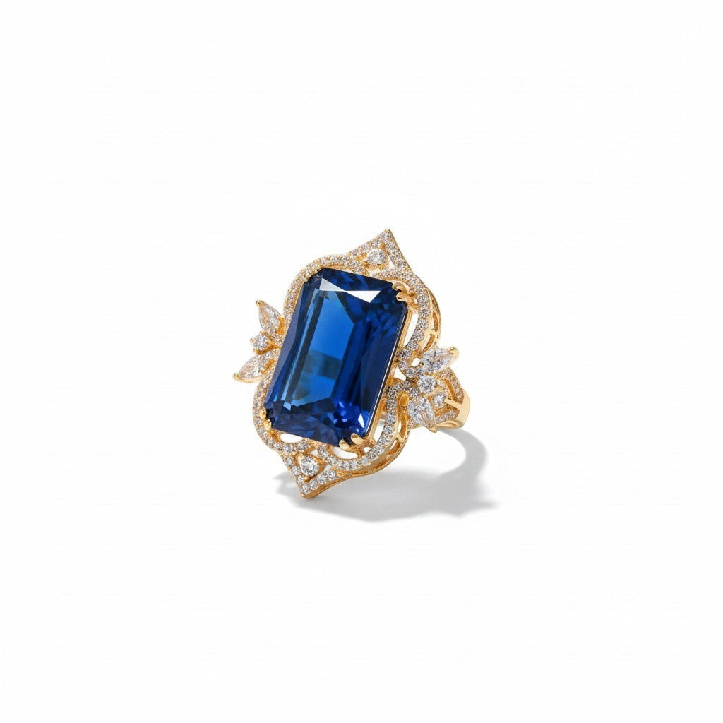 AVIRI 14k yellow gold ring with large emerald-cut blue gemstone and diamond accents.