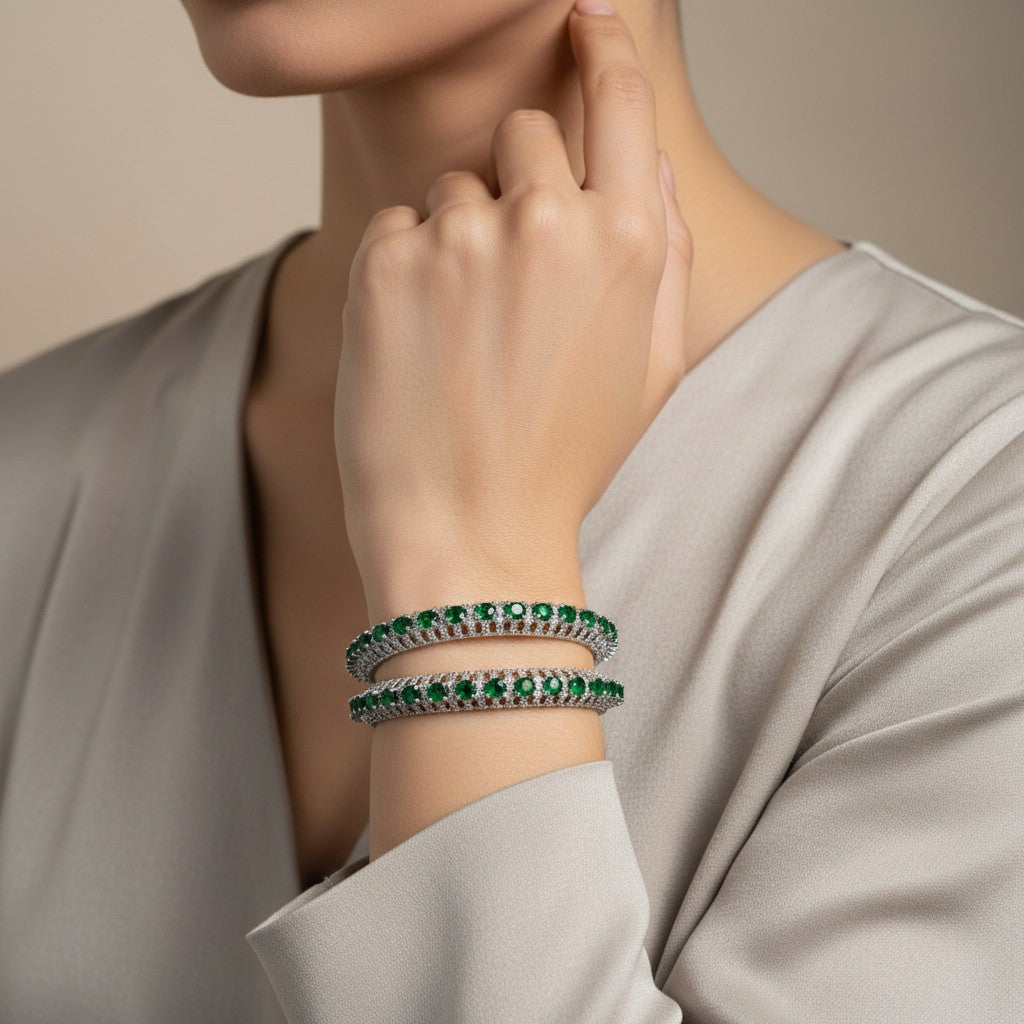 AVIRI emerald and diamond bangle bracelet set with intricate metalwork, likely sterling silver or white gold.