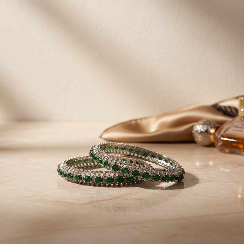 AVIRI emerald and diamond bangle bracelet set with intricate metalwork, likely sterling silver or white gold.