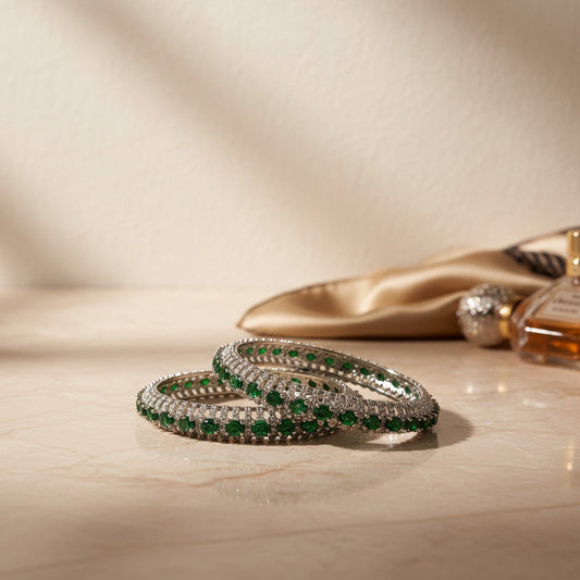 AVIRI emerald and diamond bangle bracelet set with intricate metalwork, likely sterling silver or white gold.