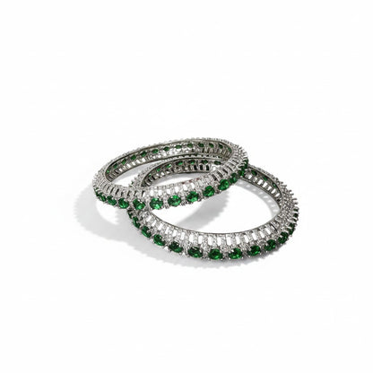 AVIRI set of two silver-tone bangles with green emeralds and white diamonds. Intricate metalwork.