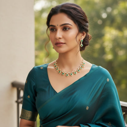AVIRI gold-tone necklace and earring set with emerald-cut green stones and clear crystals.