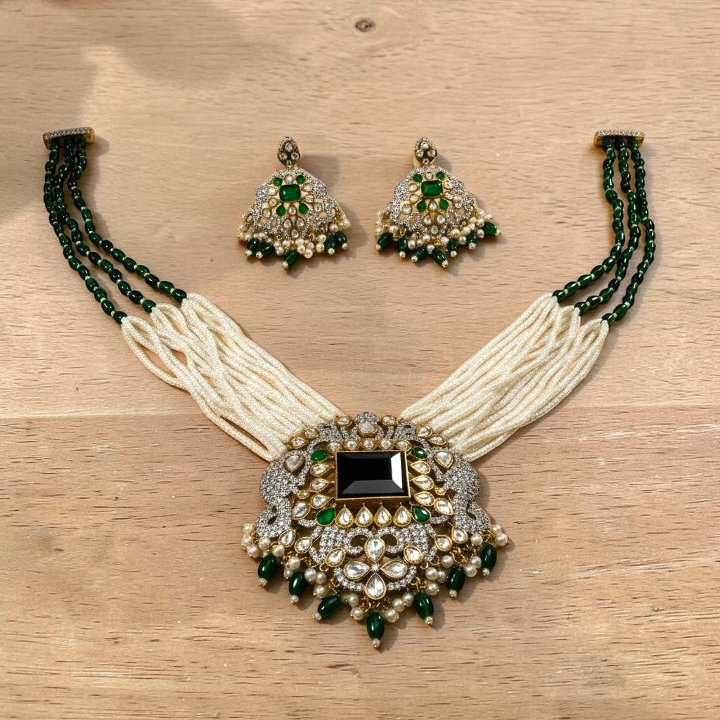 AVIRI emerald and pearl necklace set with black onyx centerpiece, white stones, and matching drop earrings.