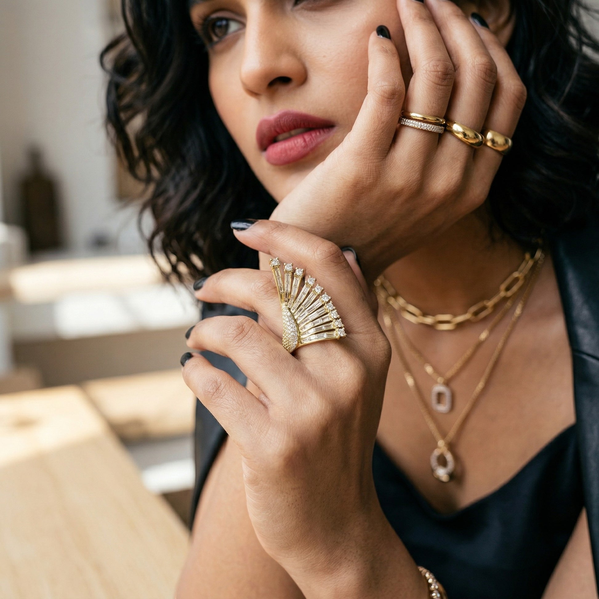 AVIRI gold fan-shaped ring with baguette and round-cut cubic zirconia stones. Statement cocktail ring.