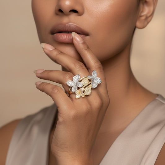 AVIRI floral cluster statement ring with pave details in gold and silver tones. Features intricate flowers encrusted with shimmering stones.