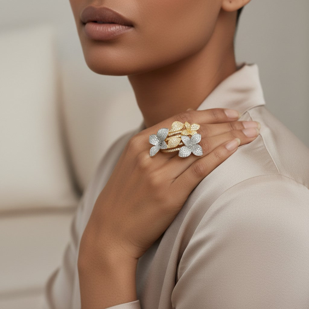 AVIRI floral cluster statement ring with pave details in gold and silver tones on a woman's hand.