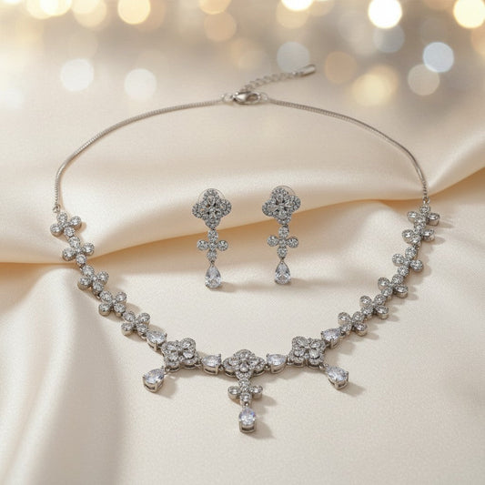 AVIRI floral cubic zirconia necklace and earring set with teardrop pendants and rhodium-plated finish.