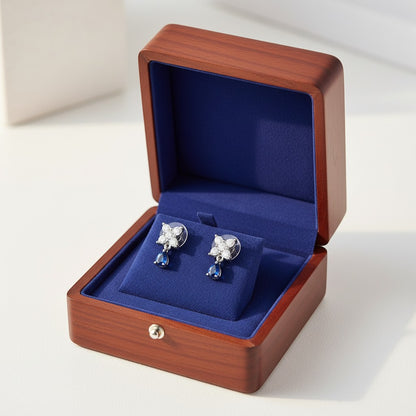AVIRI floral drop earrings with pear shaped blue gemstones and cubic zirconia in silver-tone metal.