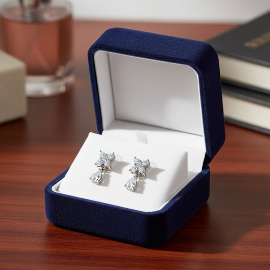 AVIRI floral drop earrings with pear shaped blue cubic zirconia gemstones and silver-tone metal.