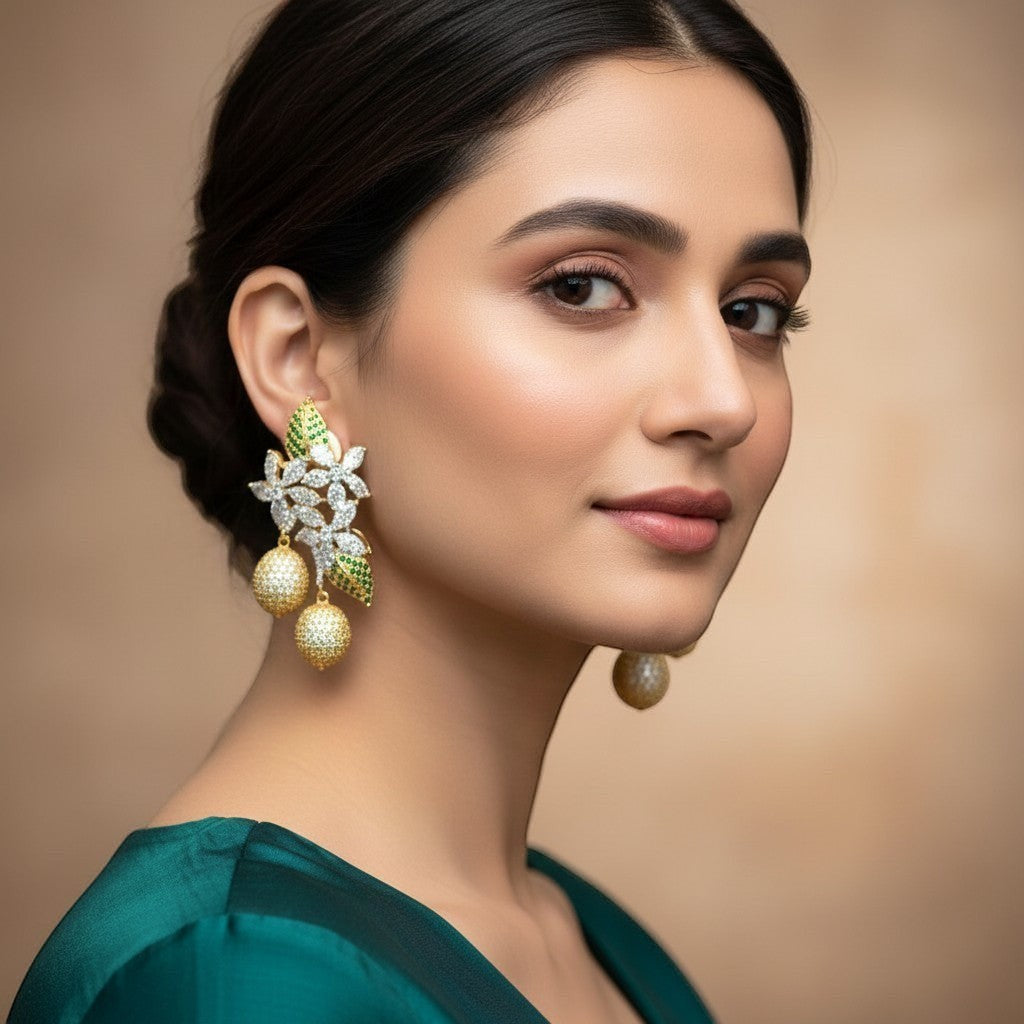 AVIRI gold-tone floral drop earrings with green stones, cubic zirconia, and spherical pendants.