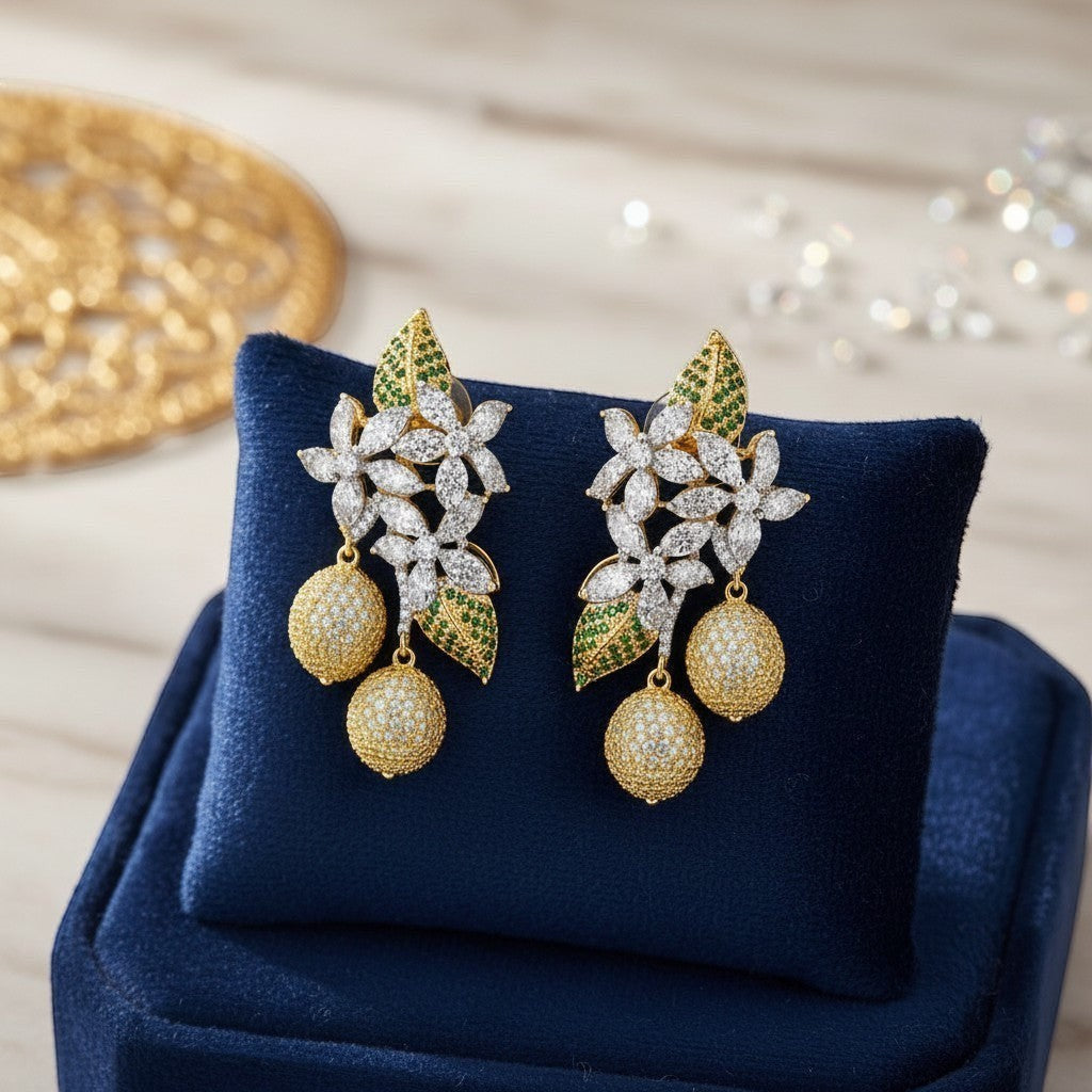 AVIRI floral drop earrings with cubic zirconia, green stones, and gold-tone spherical pendants.