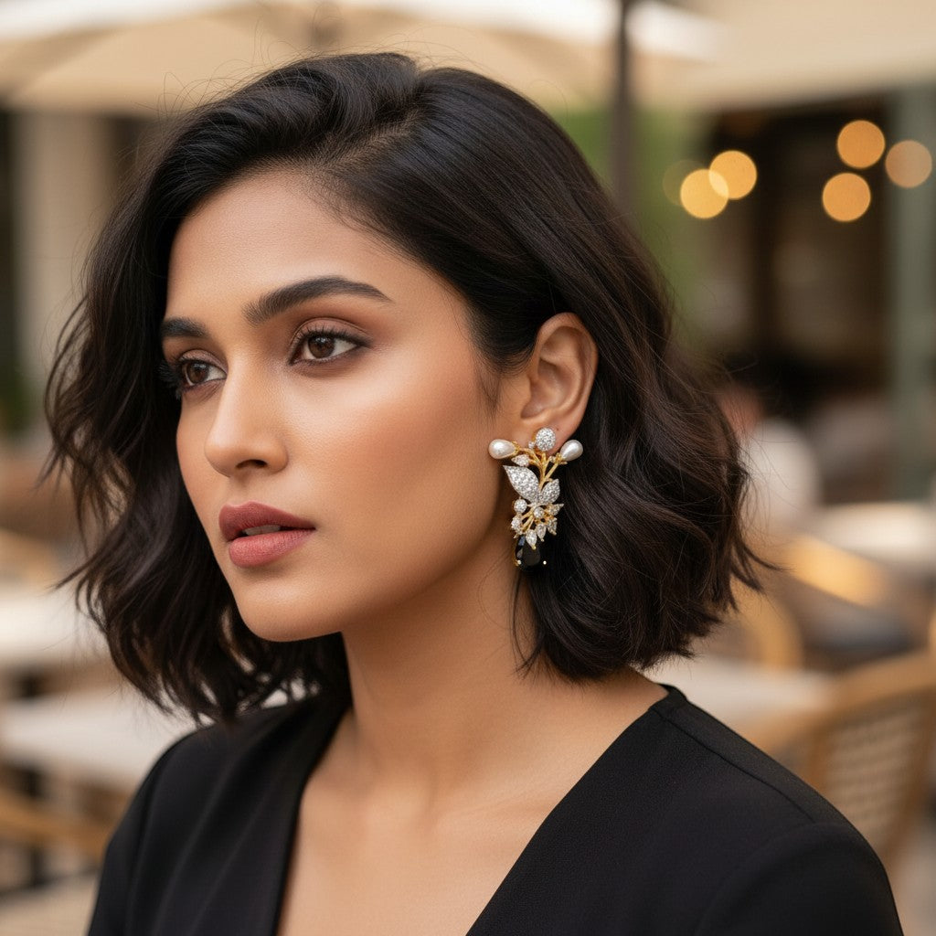 AVIRI gold-tone floral brooch with pearls, cubic zirconia, and black onyx gemstone.