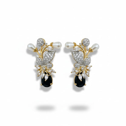 AVIRI floral brooch with pearls, cubic zirconia, and black onyx gemstone. Gold and silver tone.