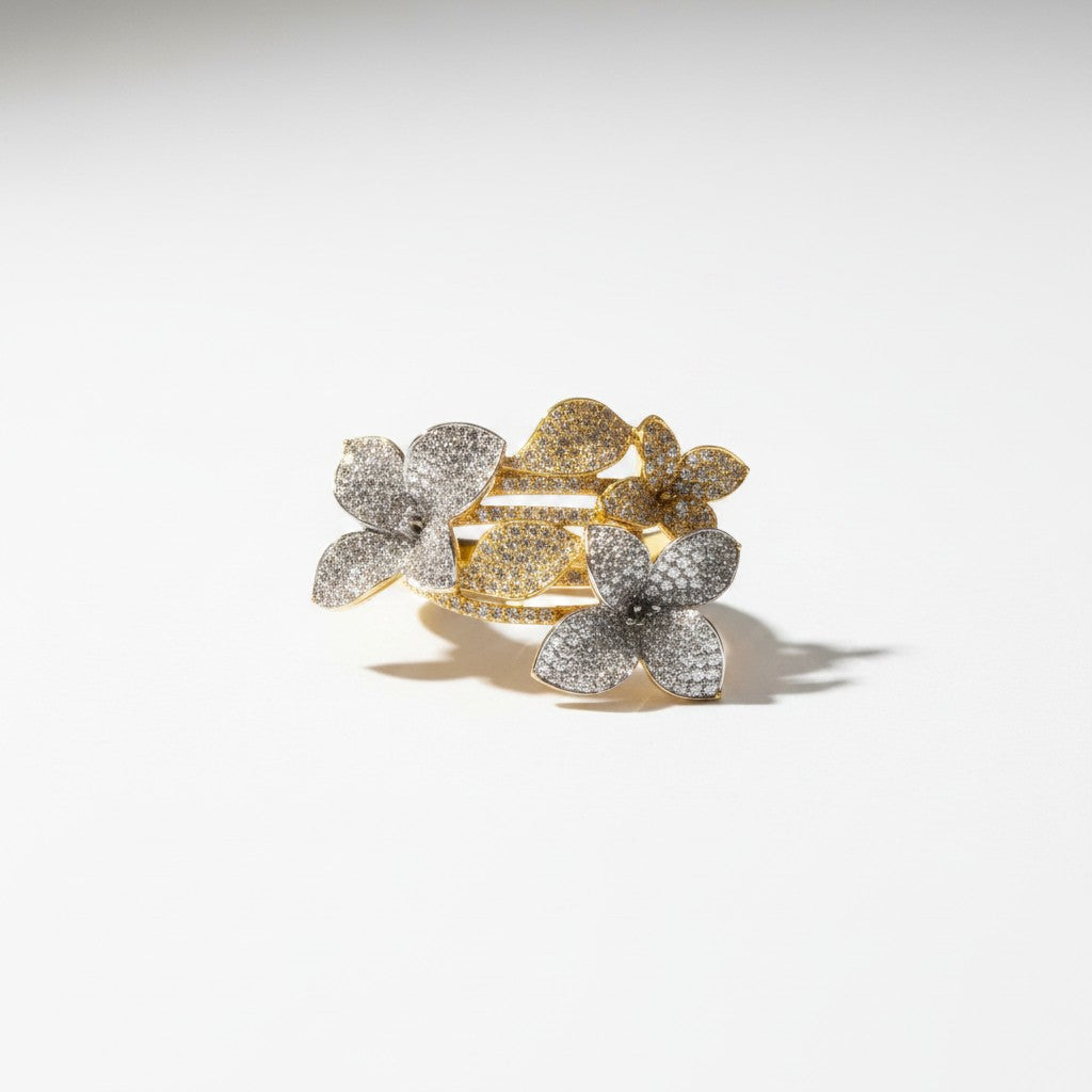 AVIRI floral cluster statement ring with pave details in gold and silver tones. Features sparkling stones on flower motifs.