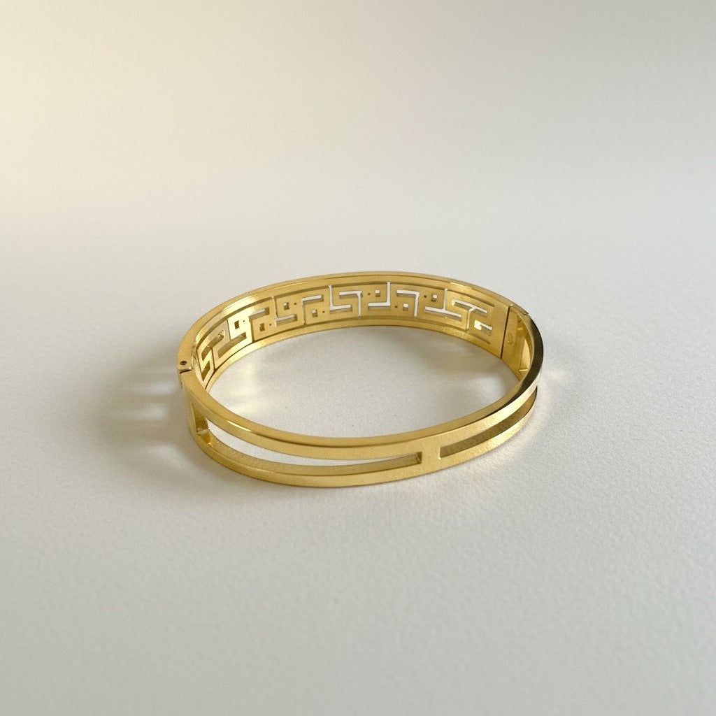AVIRI gold-tone geometric bangle bracelet with cut-out detailing and cubic zirconia stones.
