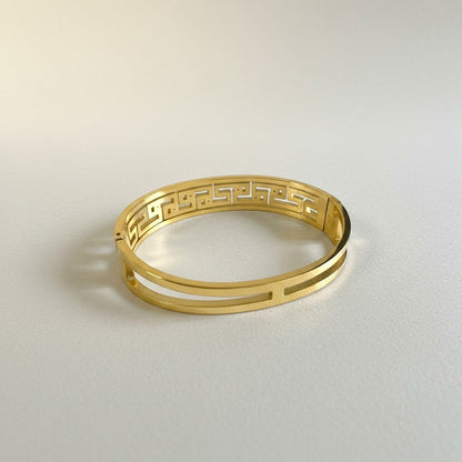 AVIRI gold-tone geometric bangle bracelet with cut-out detailing and cubic zirconia stones.
