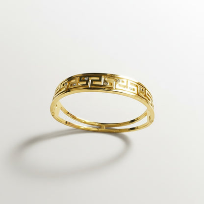 AVIRI gold-tone geometric bangle bracelet with cut-out detailing and cubic zirconia stones.