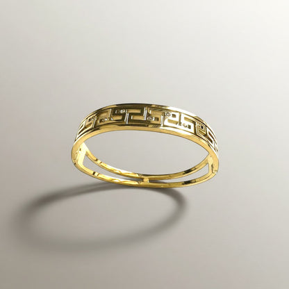 AVIRI gold-tone geometric bangle bracelet with cubic zirconia accents and intricate cut-out detailing.