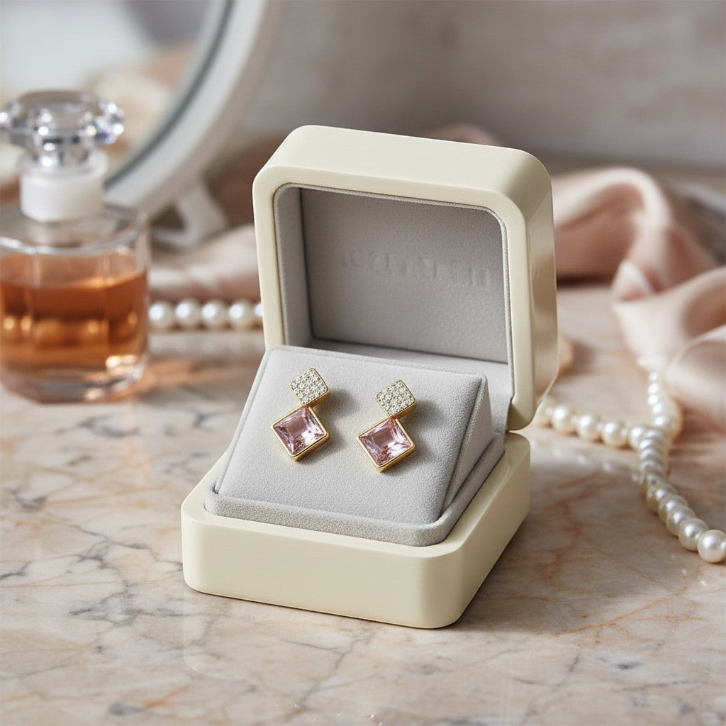 AVIRI gold drop earrings with diamond-encrusted square tops and rose quartz bottoms.