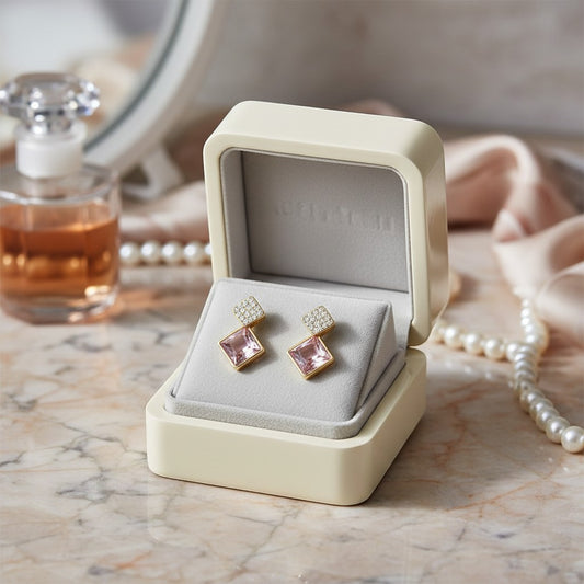 AVIRI gold drop earrings with diamond-encrusted square tops and rose quartz bottoms.