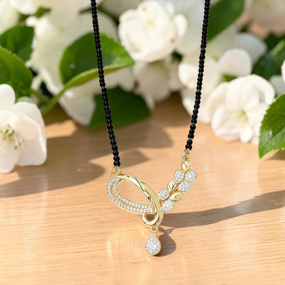 AVIRI gold-plated Mangalsutra necklace with black beads and a fluid pendant featuring shimmering white stones