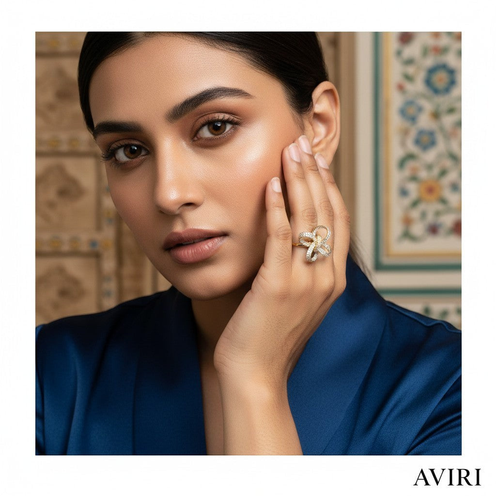 AVIRI gold bow ring with cubic zirconia stones, a delicate statement piece.