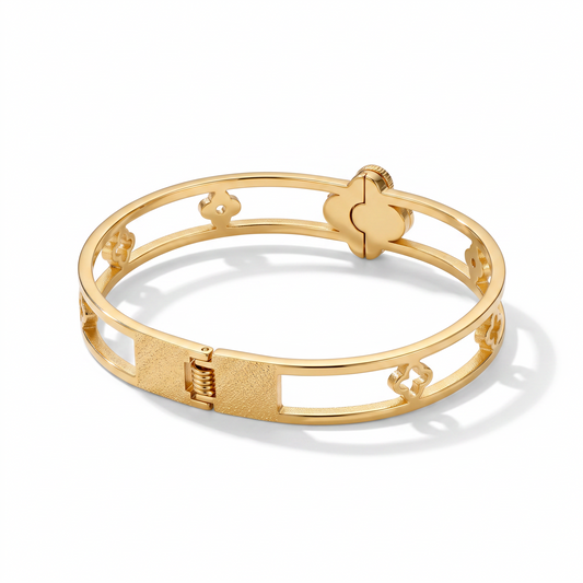 AVIRI gold-tone hinged bangle bracelet featuring a delicate open-work clover motif and a secure clasp closure.